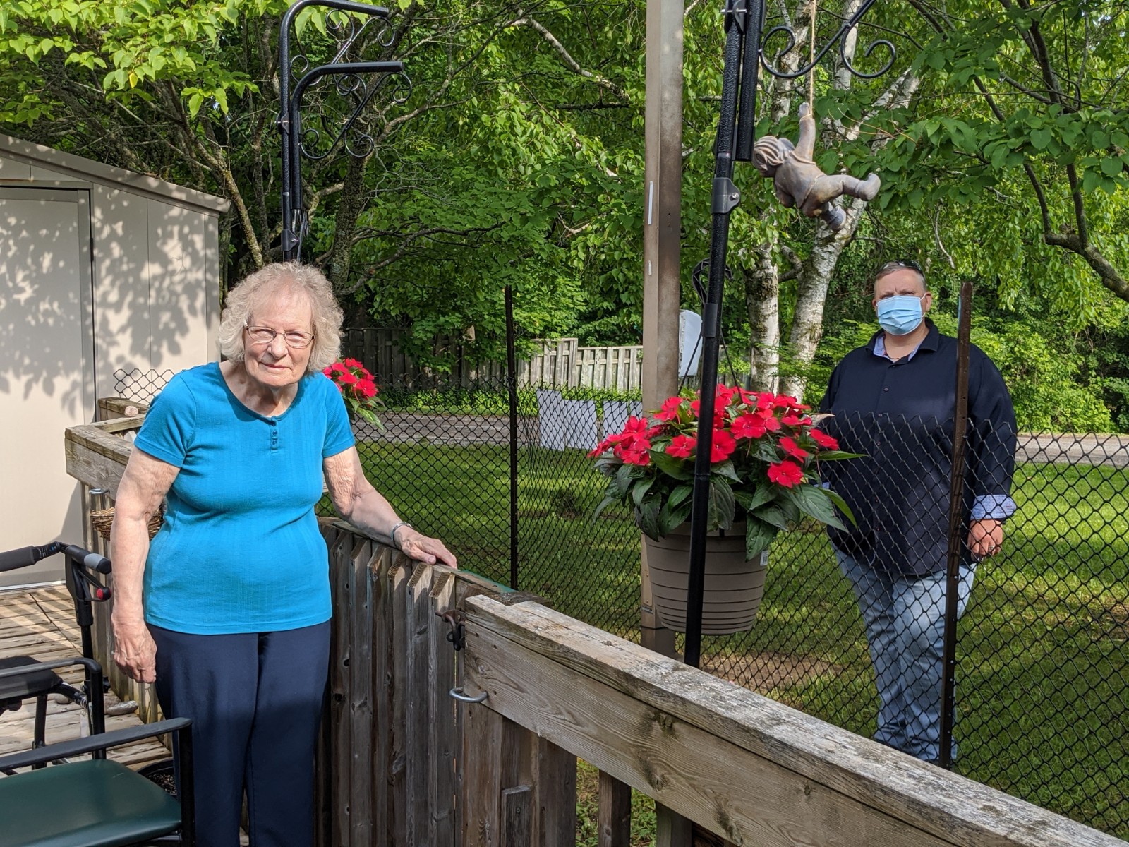 Majorie distantly visits with her granddaughter  Teresa outside Coleman Care Centre