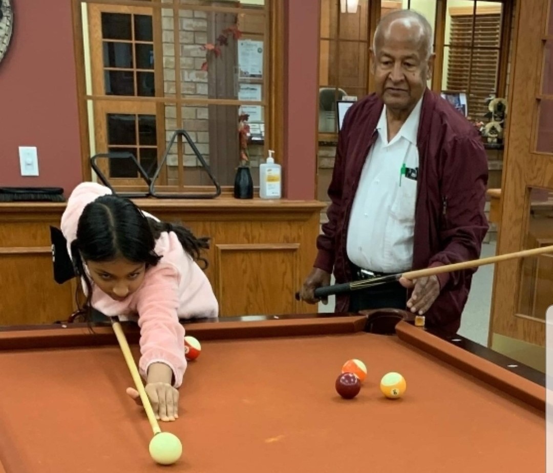 Azm and his daughter Omnia shoot a little pool together at Erin Meadows.