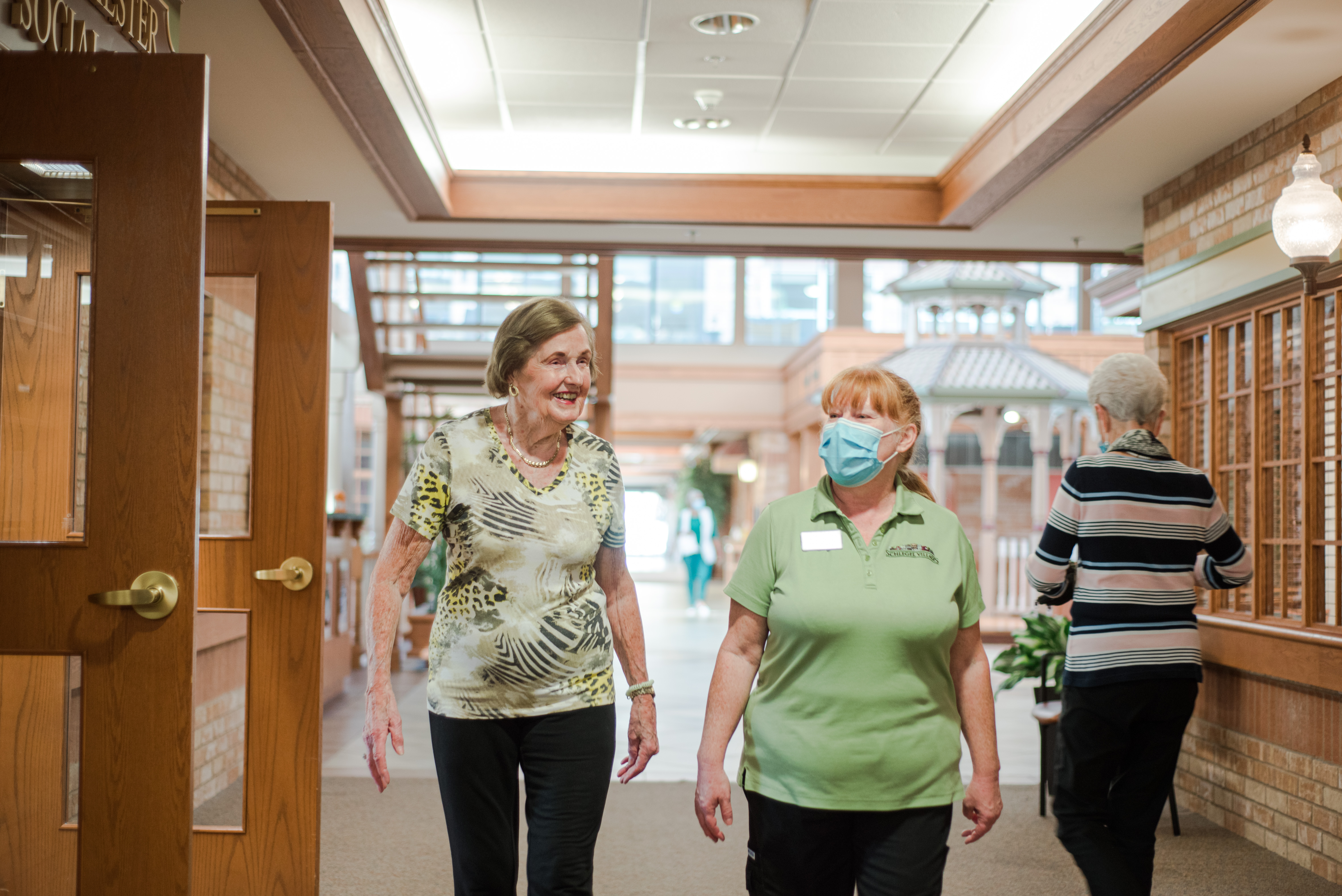 A resident and team member walking down Main Street.