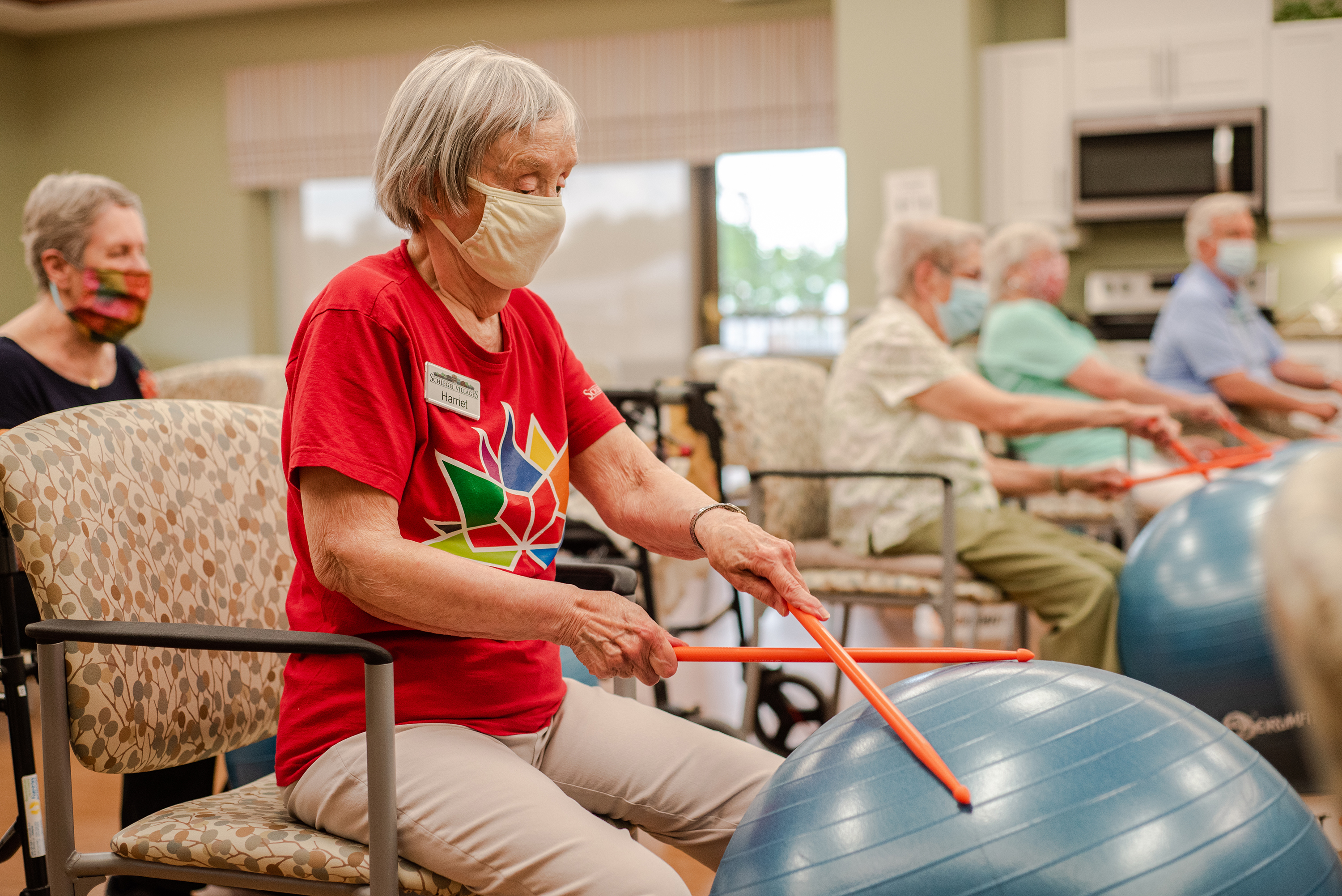 Senior participating in drum fit as part of the program for active living