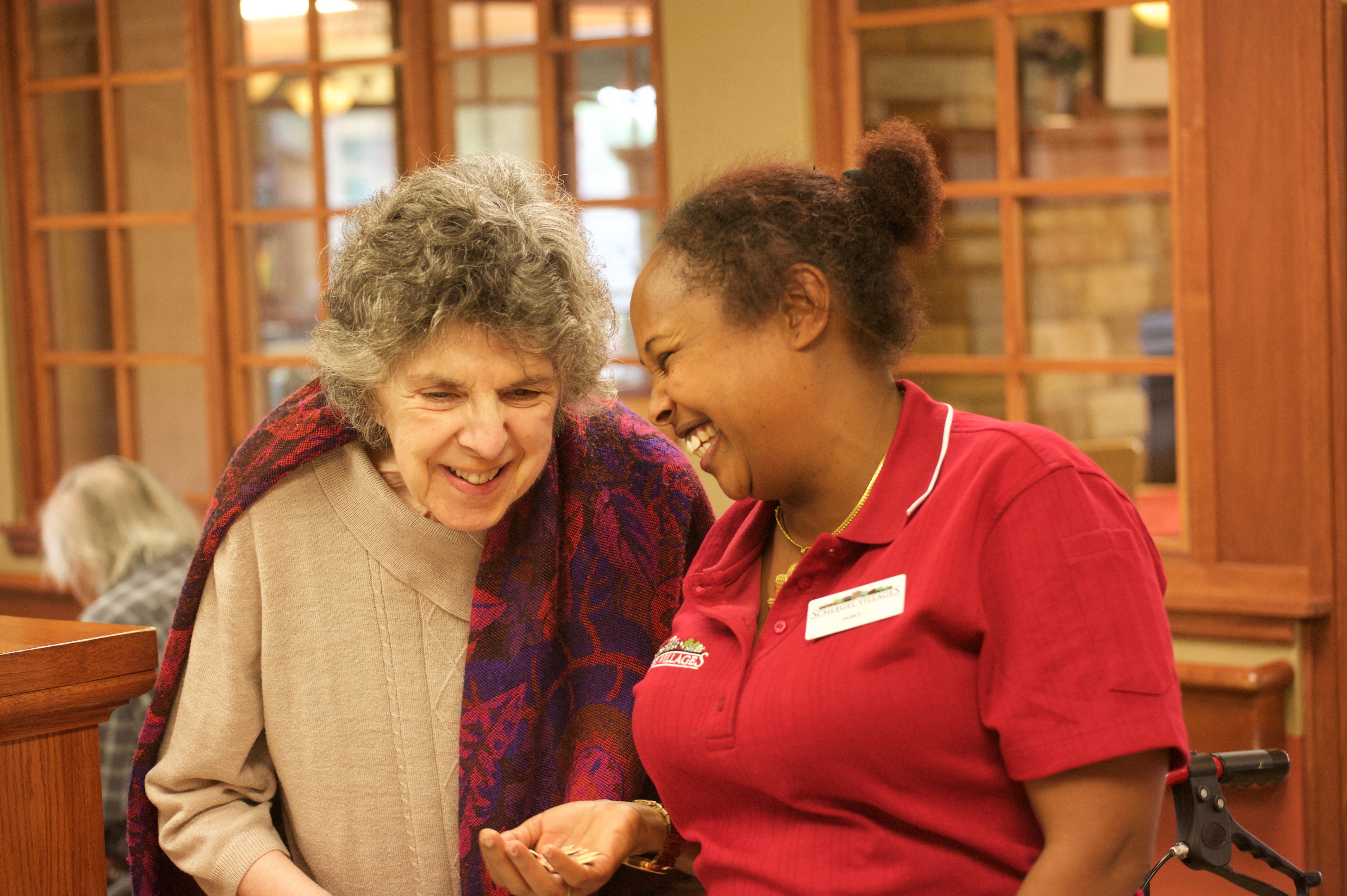 Resident and team member laughing