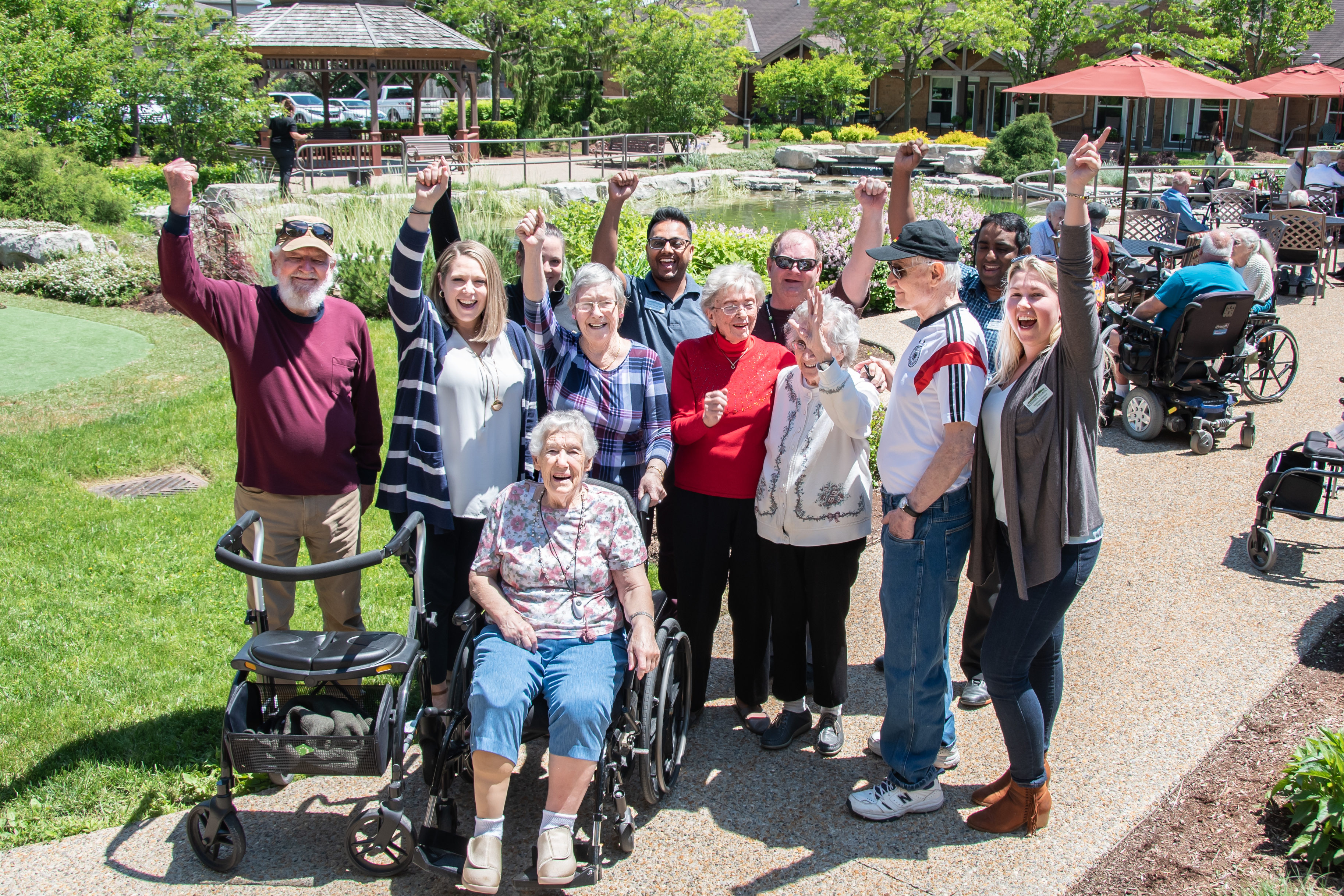 A happy group of team members and residents in a Village Courtyard