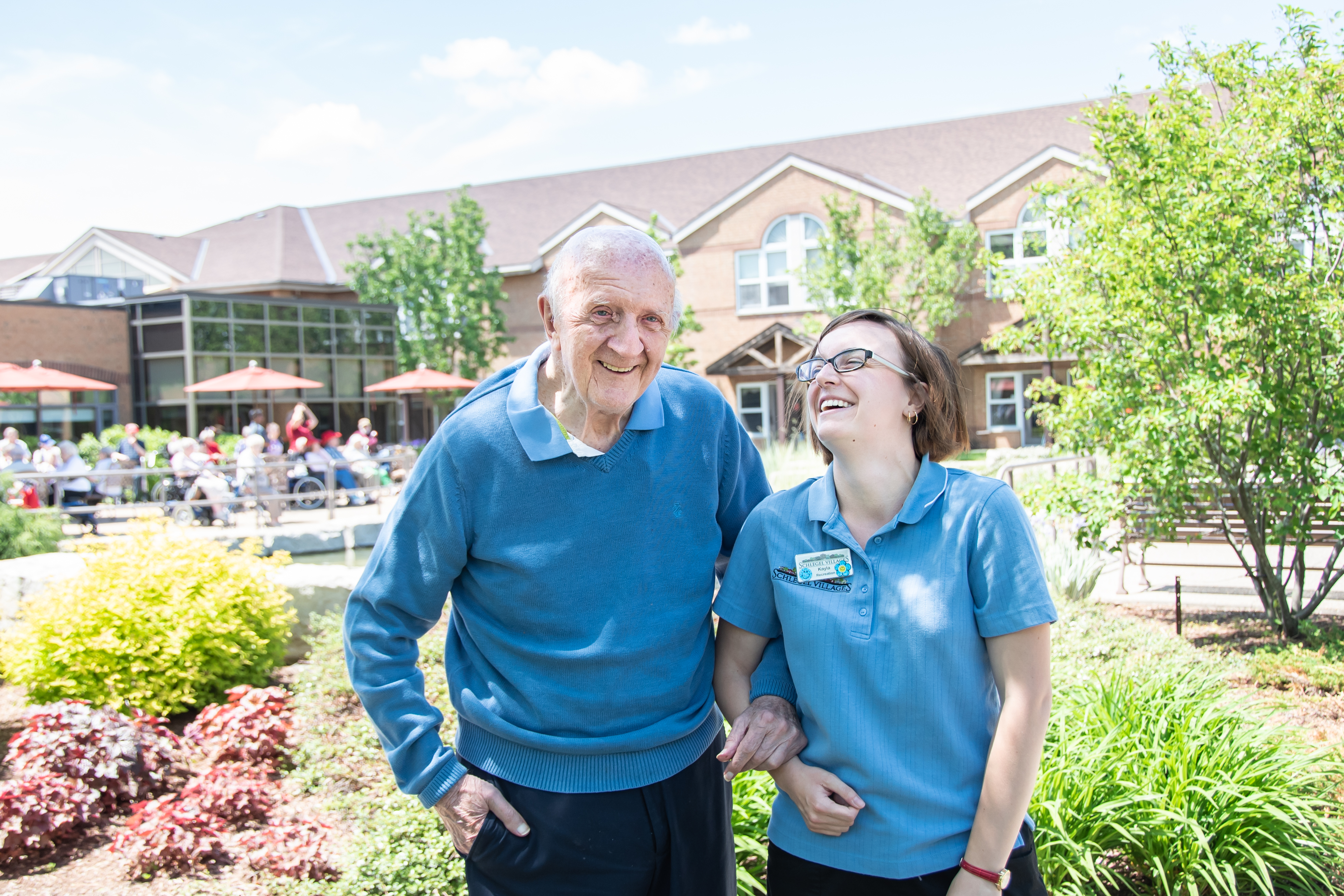 Resident and team member in the courtyard laughing