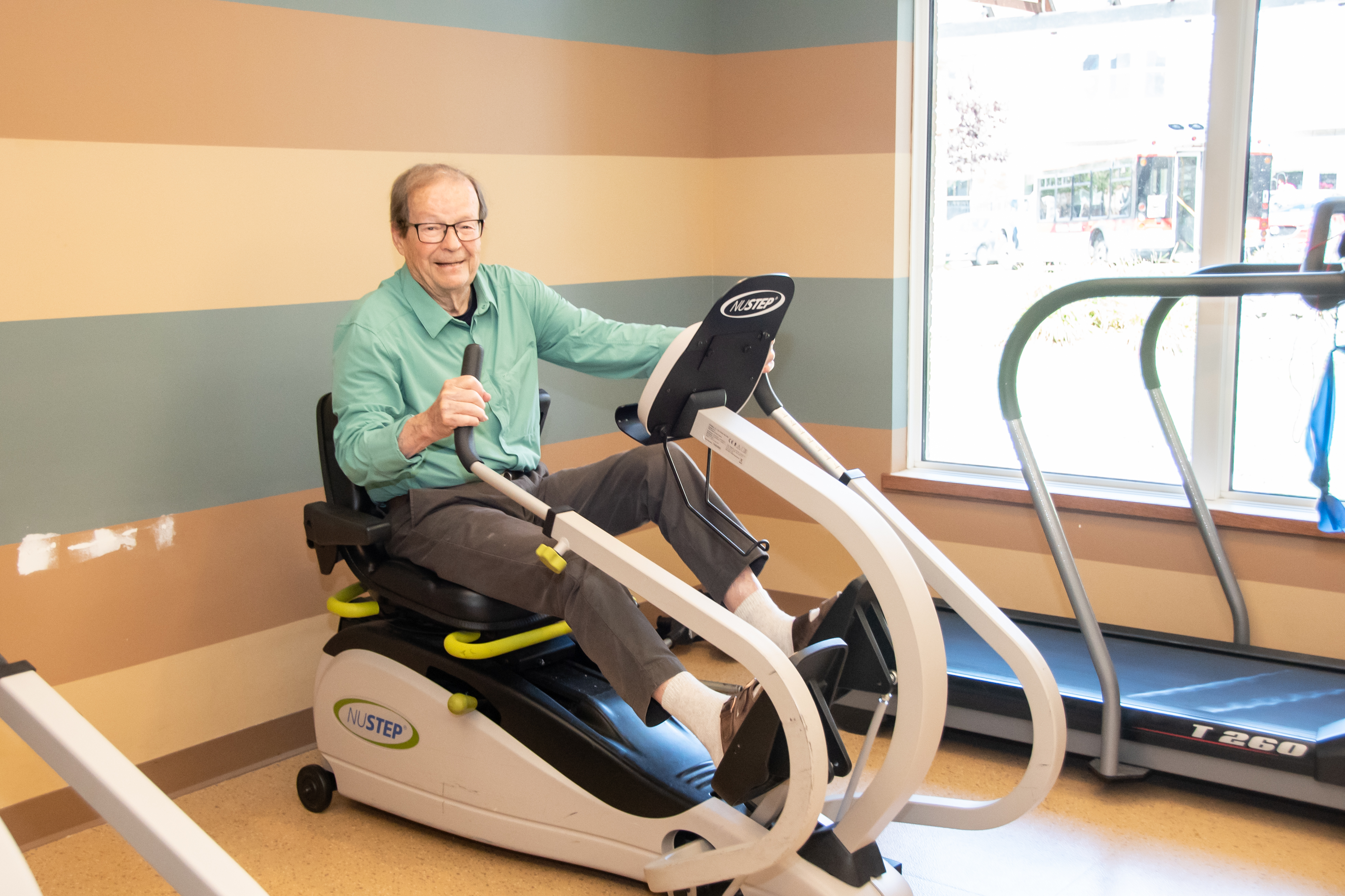 Senior man using the nustep exercise equipment