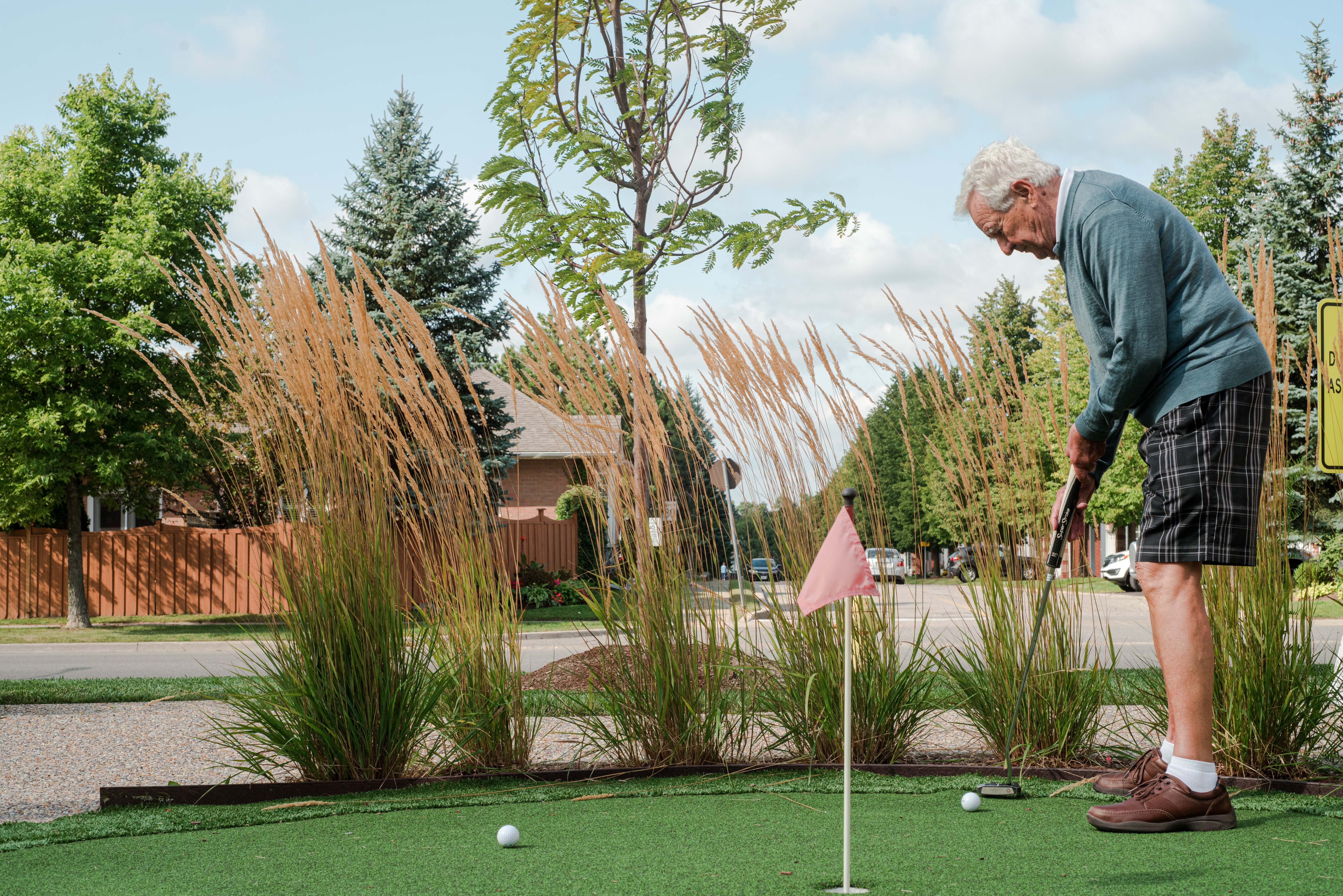 Man golfs in the Village courtyard