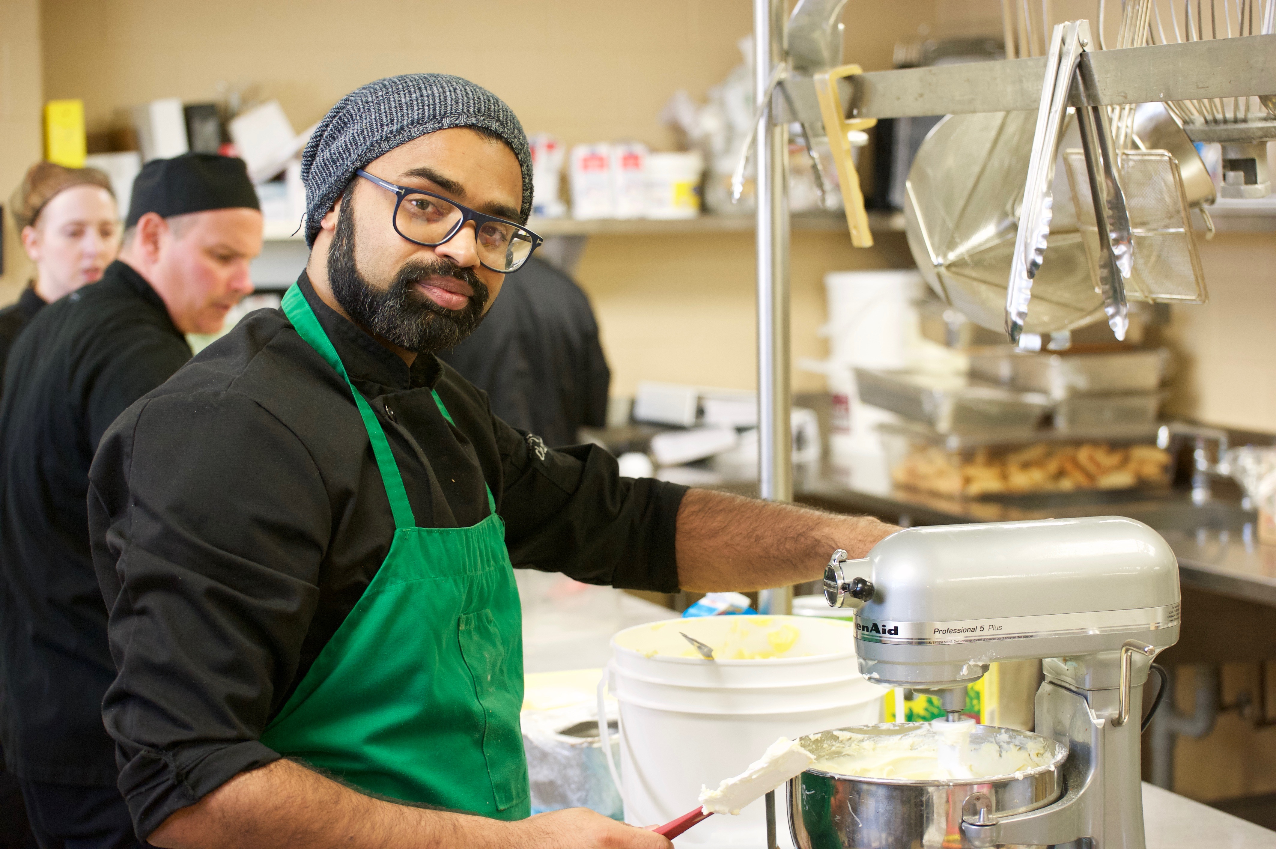 Schlegel Villages team member working in the kitchen with a mixer