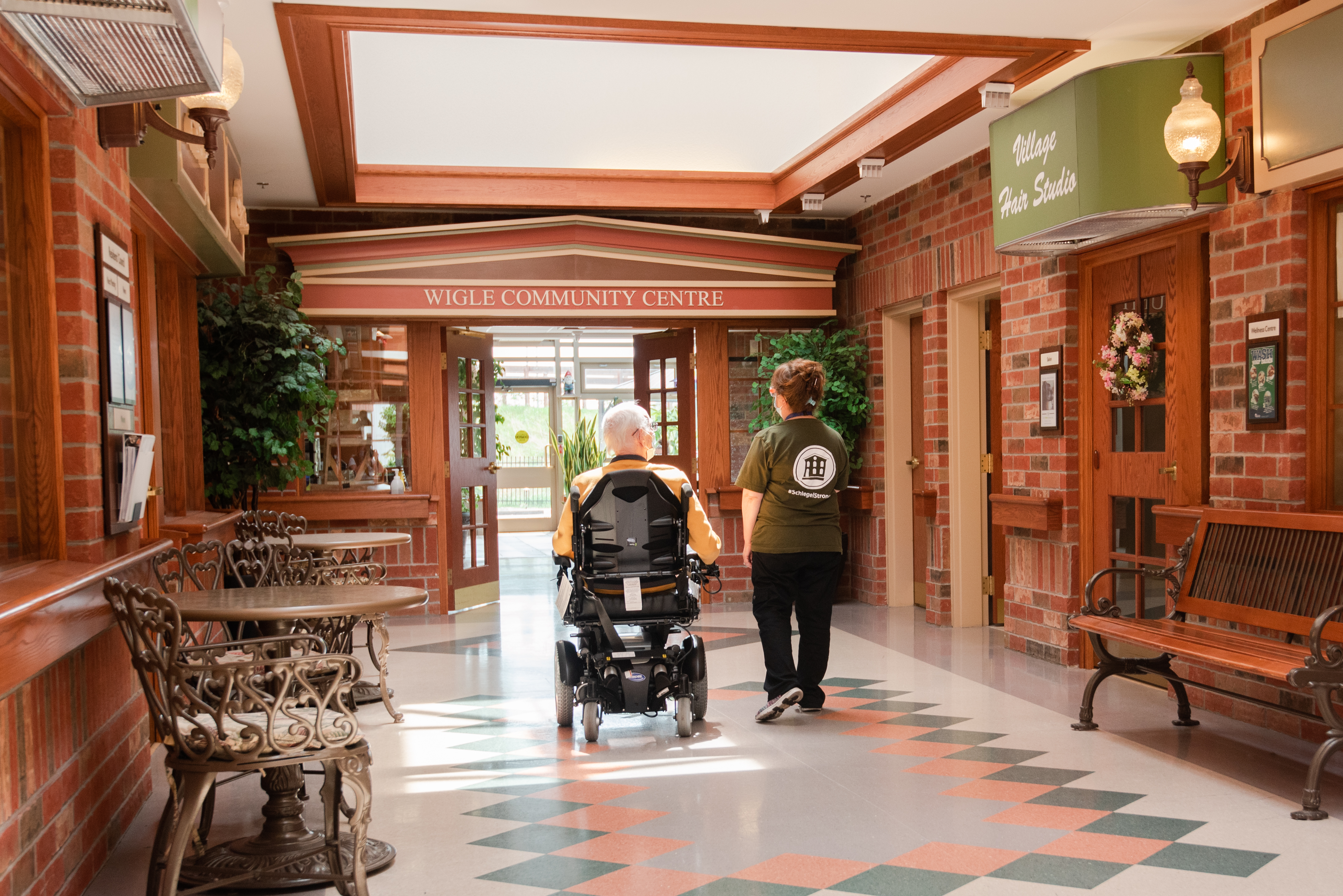 Resident and team member walking down Main Street