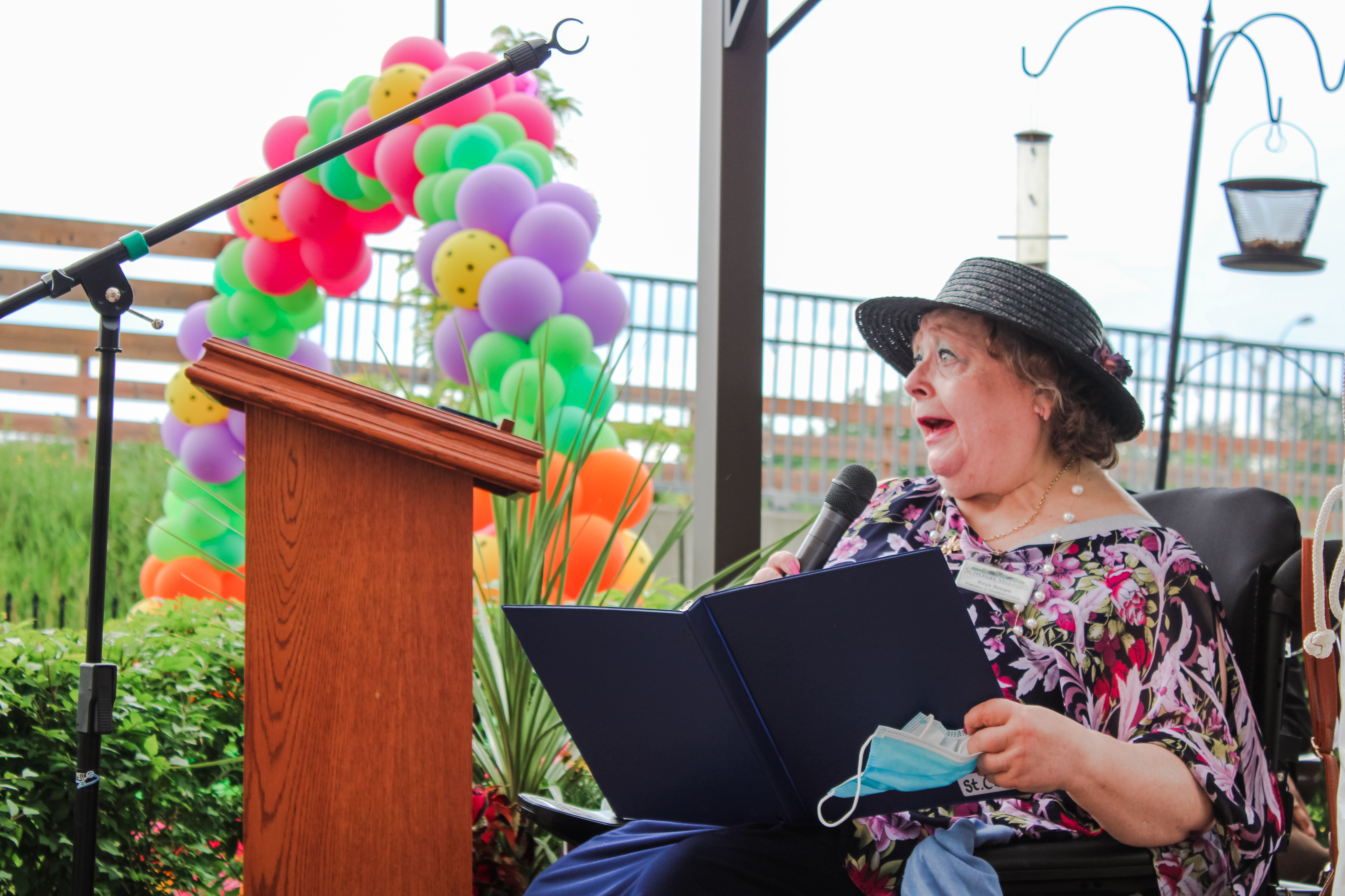 St. Clair Residents' Council President Kaye Brown offers remarks to dedicate the Village's new Healing Garden.