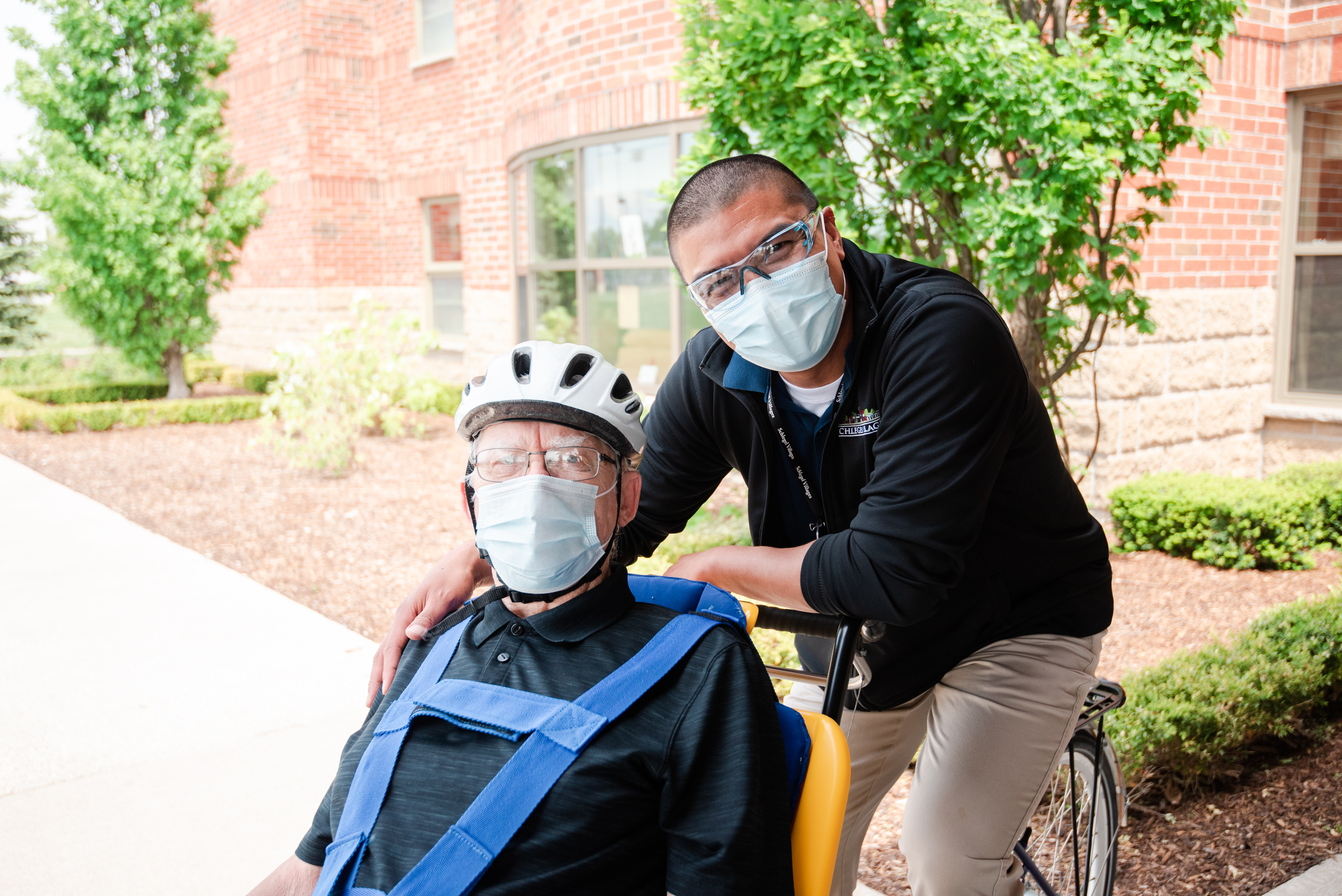 Noel and Victor ride the duet bike at The Village at St. Clair in Windsor