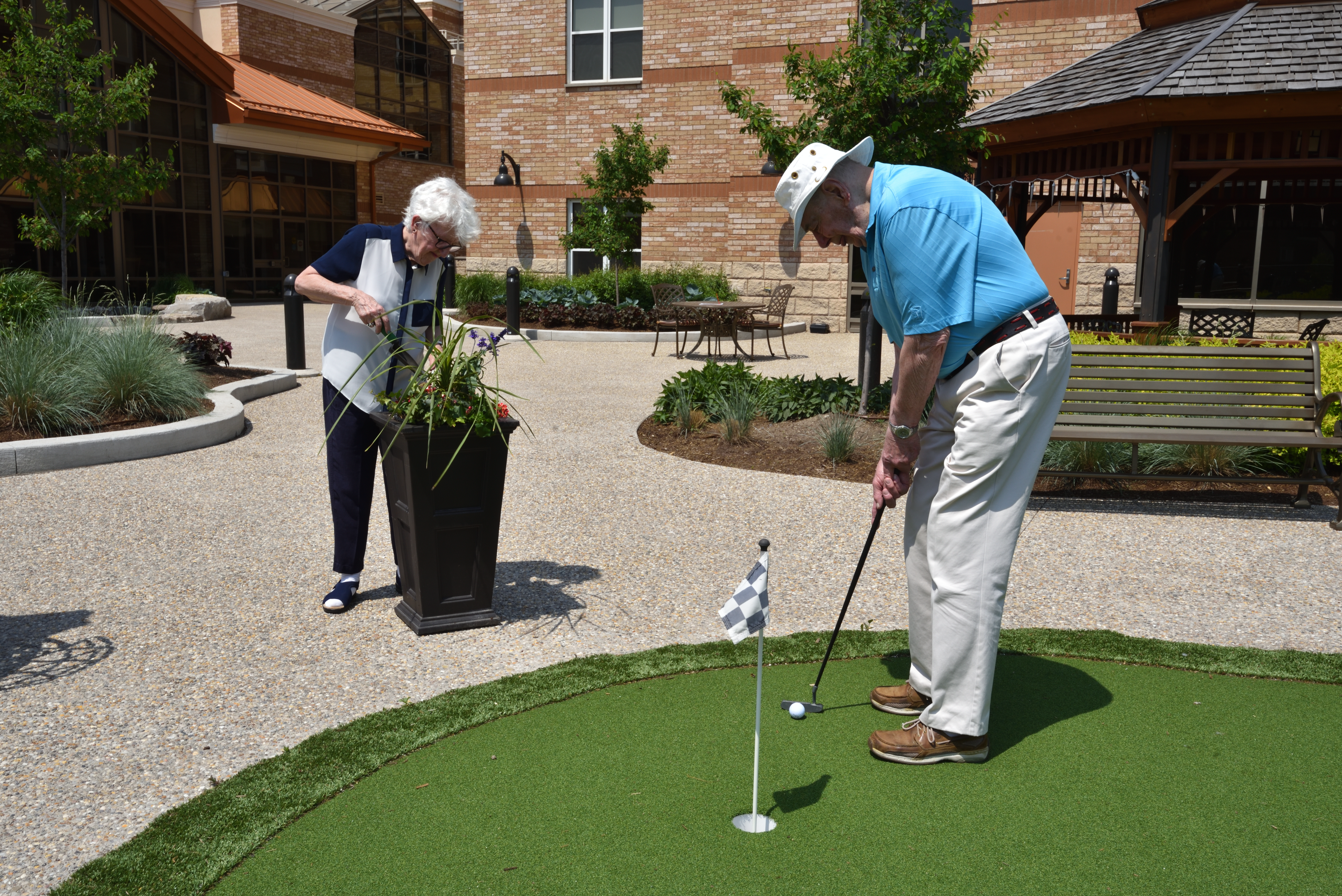 Resident couple putting and gardening in the Courtyard