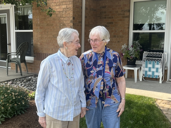 Twin sister's Nene and Nan smile outside of their Winston Park home. 