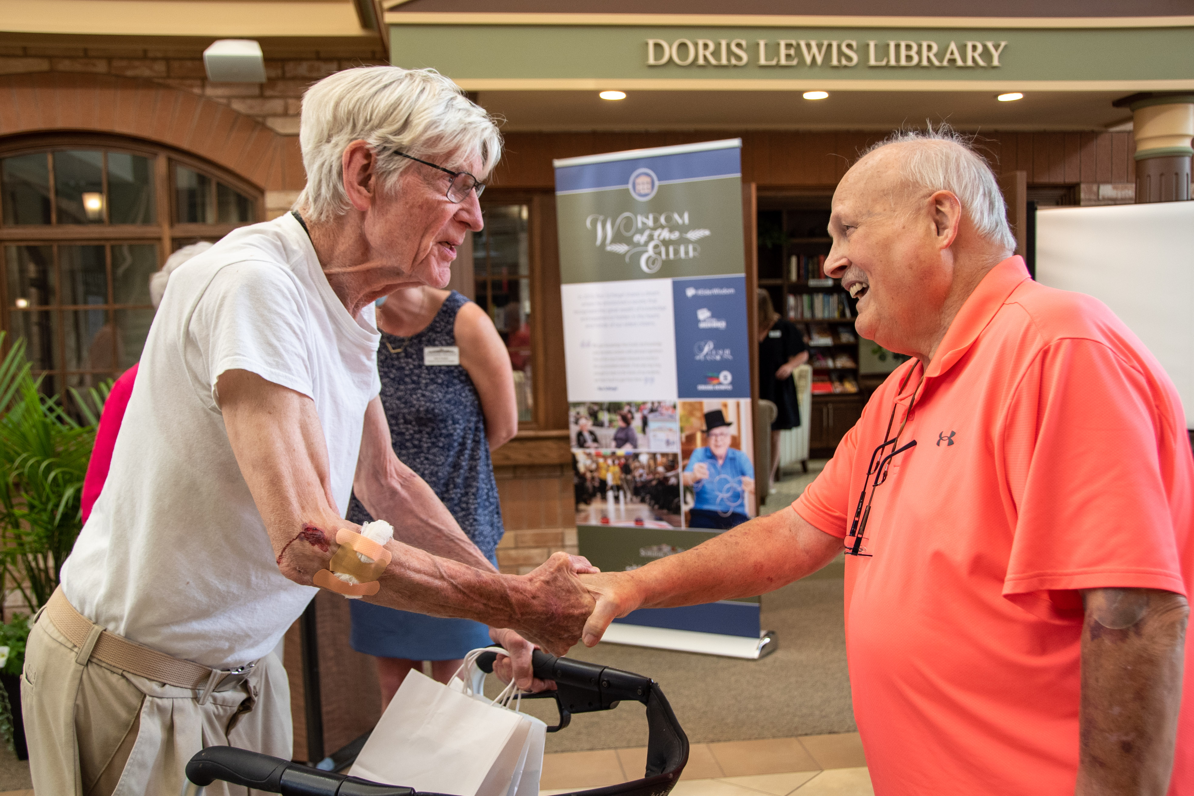 Ron Schlegel shakes hands with a resident during the gala event