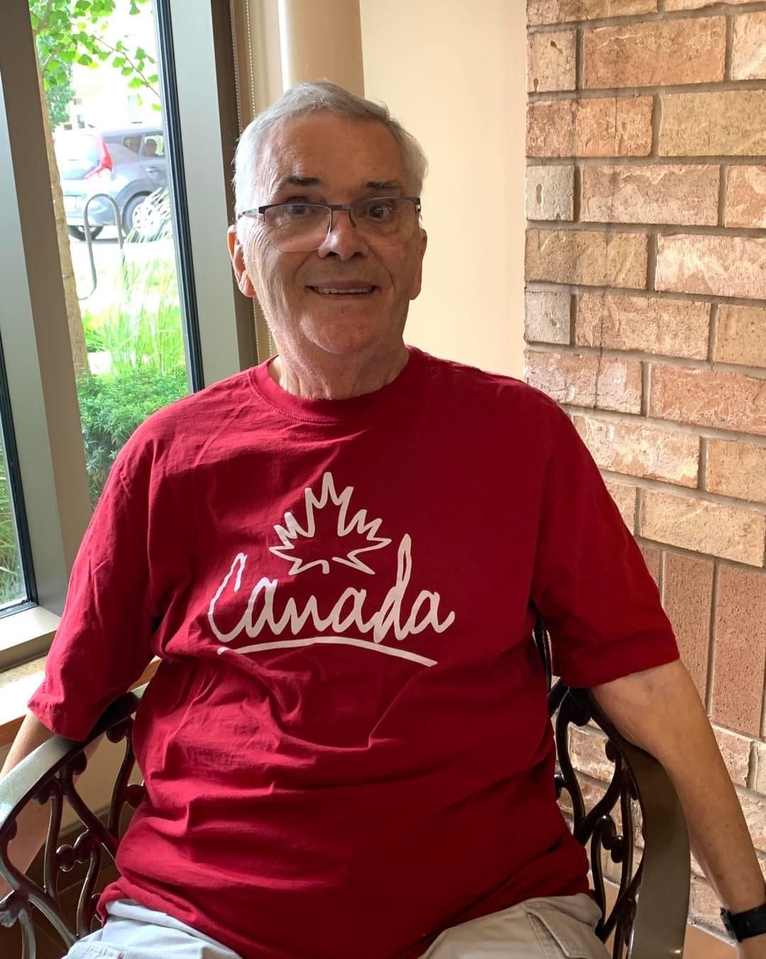 Michael smiles for the camera in his red, Canada T-shirt.