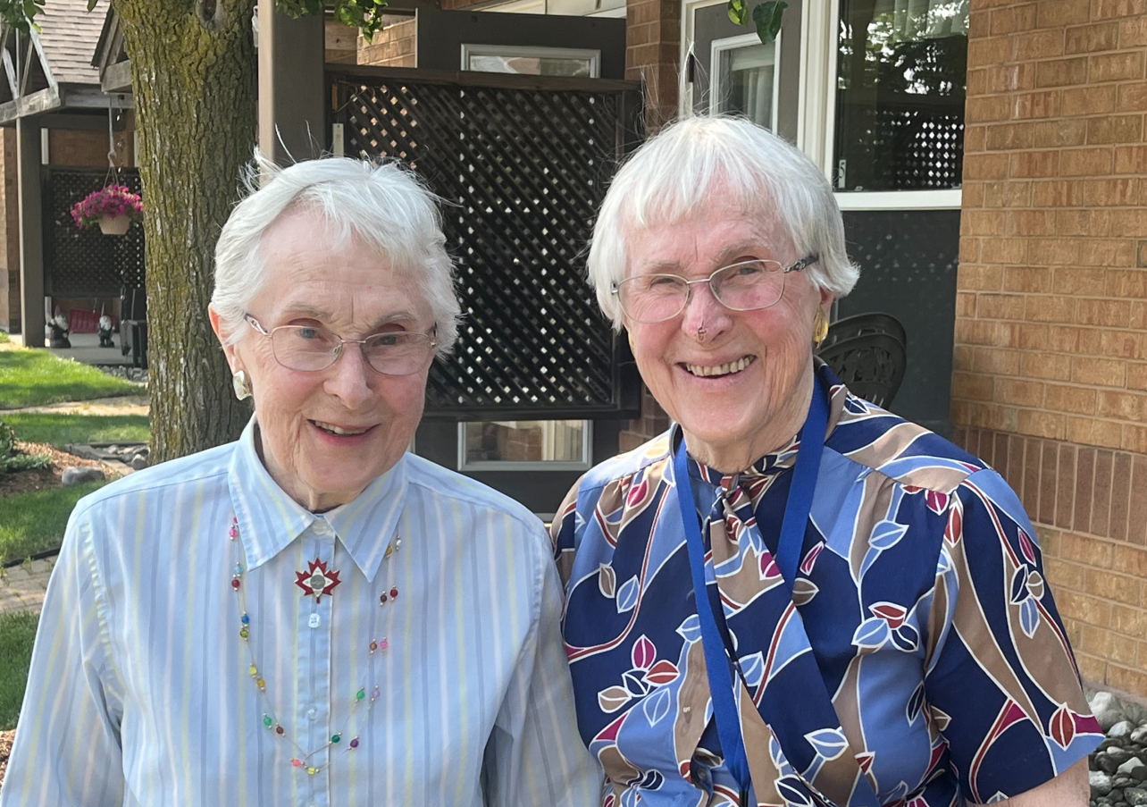 Twin sister's Nene and Nan smile outside of their Winston Park home. 