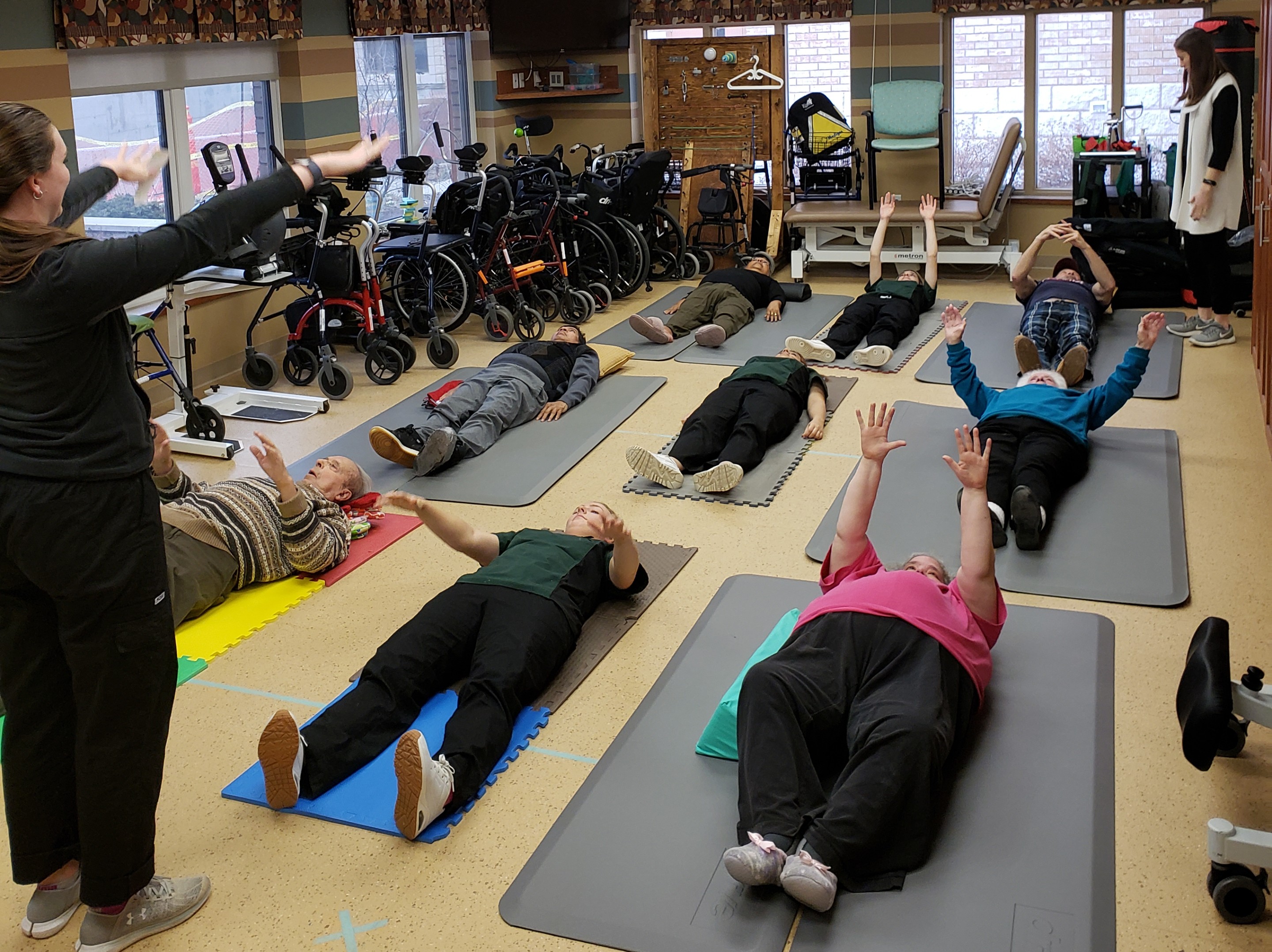 Residents in the Village at University Gates doing their floor exercises.