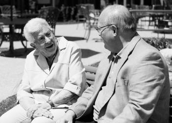 Winston Park resident Marg Cressman sharing a bench with Schlegel Villages founder Ron Schlegel