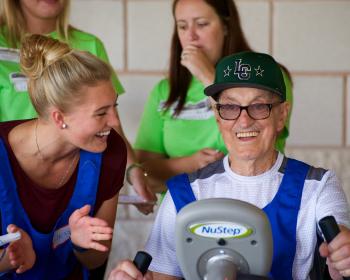 Resident working out on the Nu-Step equipment for the cycling event